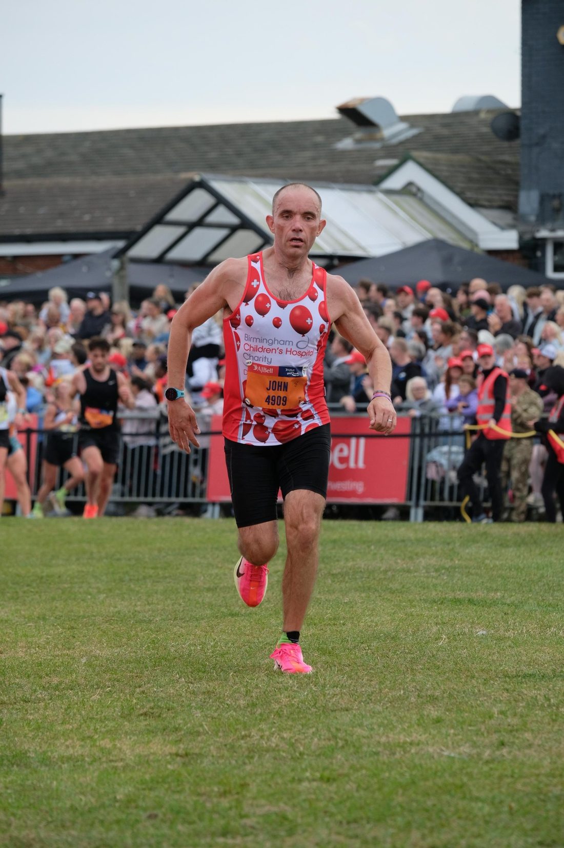 John running the final stretch of a marathon towards the finish line